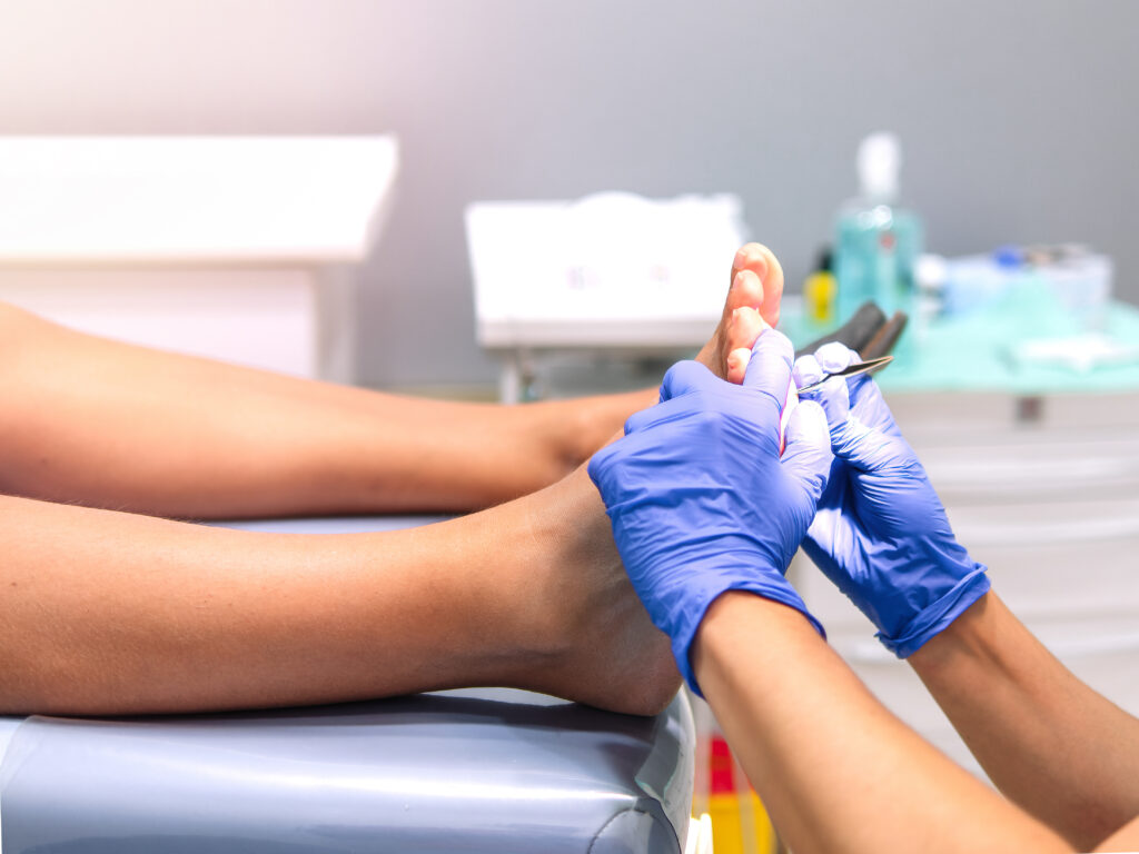 Podiatrist doing chiropody in her podiatry clinic. Selective focus